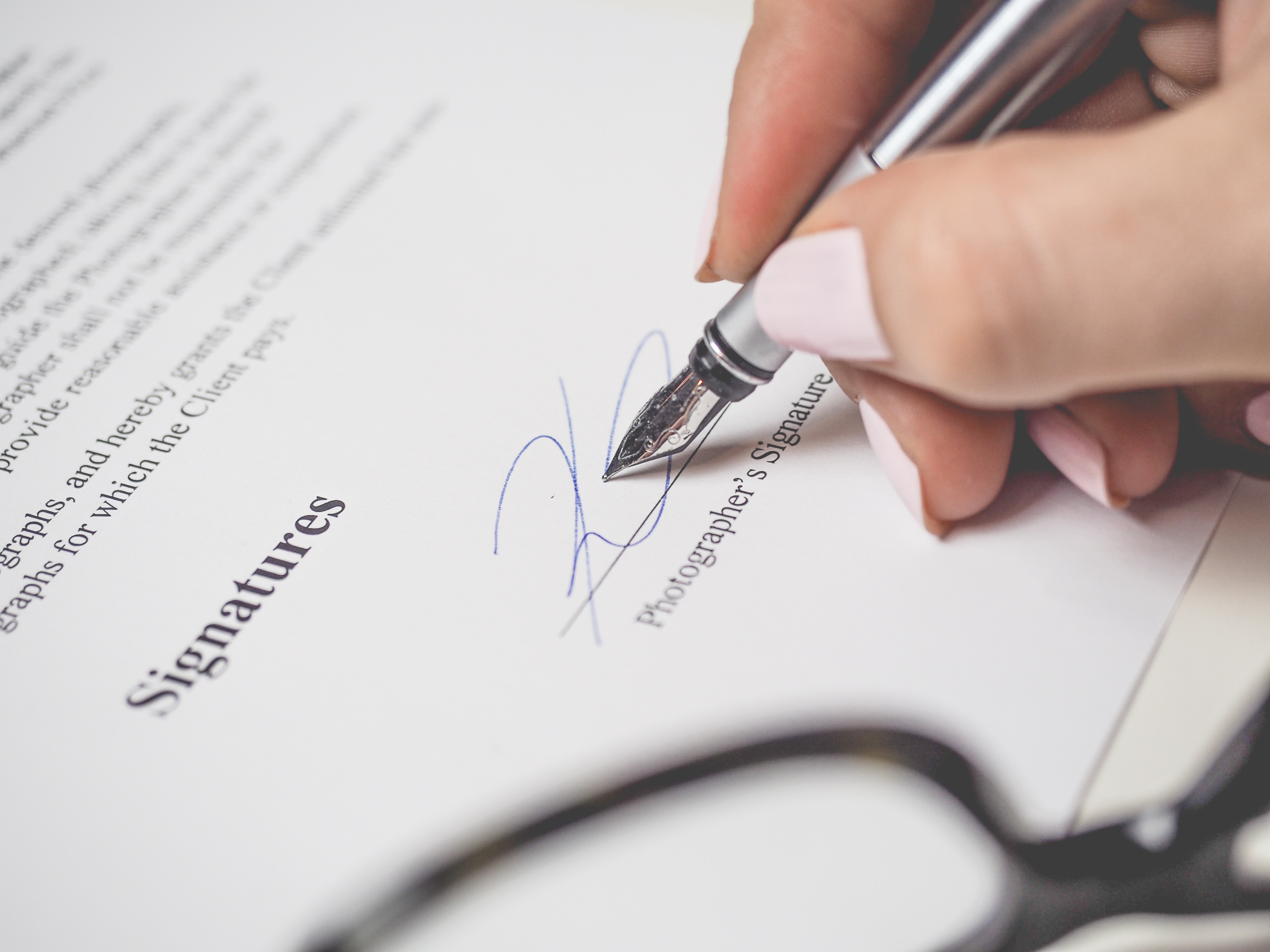 person-holding-silver-pen-signing-photographers-signature-175045 person-holding-silver-pen-signing-photographers-signature-175045